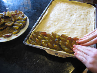 spearding layer on prunes on yeast sheet cake