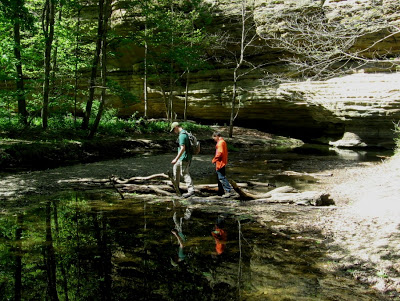 two boys hiking across shallow pools in Illinois Canyon
