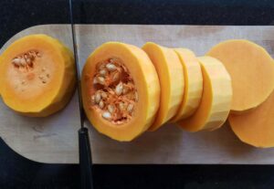 butternut squash slices on a wooden board