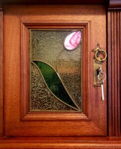antique desk window with tulip detail and key in lock