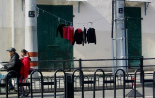 red and black laundry hung out to dry on street in Shanghai