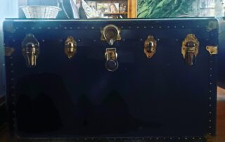 black steamer trunk front with grass locks